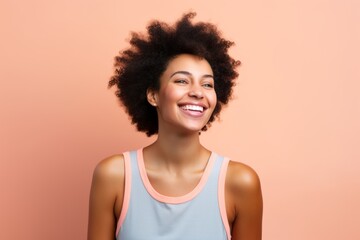 Portrait of a joyful afro-american woman in her 20s dressed in a high-performance basketball jersey...