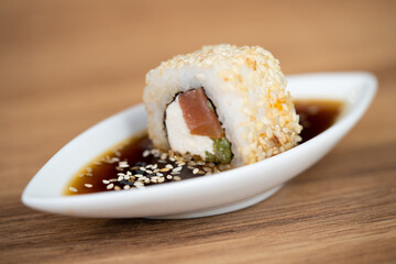 delicious traditional Japanese sushi and rolls on a plate in soy sauce