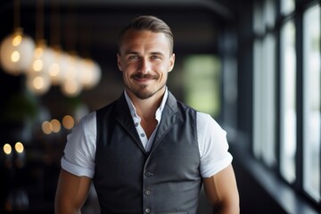 Obraz premium Portrait of a glad man in his 30s dressed in a breathable mesh vest on scandinavian-style interior background