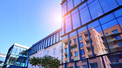 A renovation residential building and an adjacent modern office building. Modern urban development.