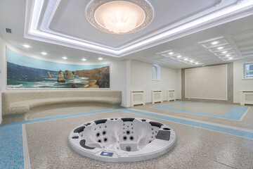 Magnificent interior design in a luxurious mansion. Modern bathtub with hydro massage. A wall panel...