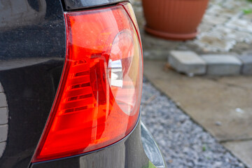 Close-up of a car's taillight showing intricate details and reflections. A vibrant image...