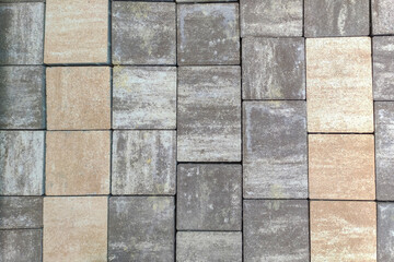 Fototapeta premium Textured paving stones in a unique pattern create an interesting backdrop for design projects. Perfect for construction, landscaping or home renovation visuals.