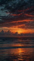 Obraz premium Stunning sunset over calm sea with vibrant hues blending into darkening sky.