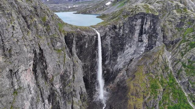 Epic waterfall in clouds zoom out drone shot, double waterfall of Mardalsfossen in Norway in 4K.