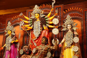 an idol of indian goddess durga with other goddess killing mahishasur in durga pooja