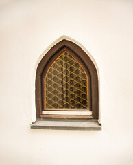 Gothic-style window and antique stone wall