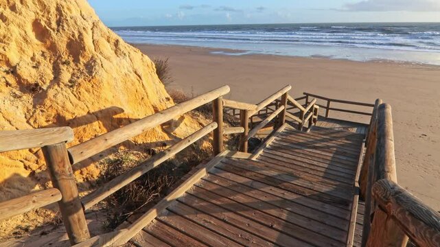 Walkway with wooden steps on Cuesta Maneli beach, located in a very unique environment, the fossil dune system of El Asperillo, located within the Do&ntilde;ana Natural Park , Huelva, Spain.