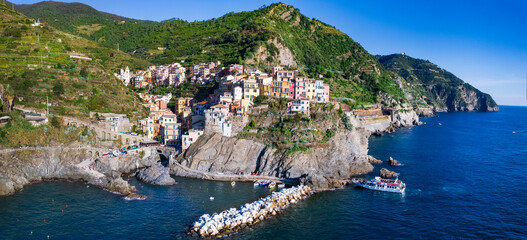Italy, Cinque terre famous national park of traditional fishing villages. Manarola . Aerial drone view of colorful houses and picturesque bay. popular tourist attraction in Liguria