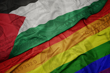 waving colorful flag of palestine and gay rainbow flag on the dollar money background. finance...