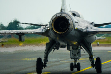 Swirling hot air behind the turbine exhaust of a working fighter jet, blurred photo