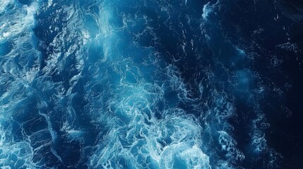 Deep blue ocean waves captured from above, showing movement and depth