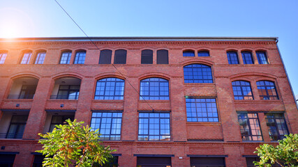 Modern loft building from red brick in downtown area.  Industrial design in city architecture. Business concept.