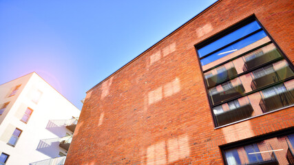 Modern loft building from red brick in downtown area.  Industrial design in city architecture. Business concept.