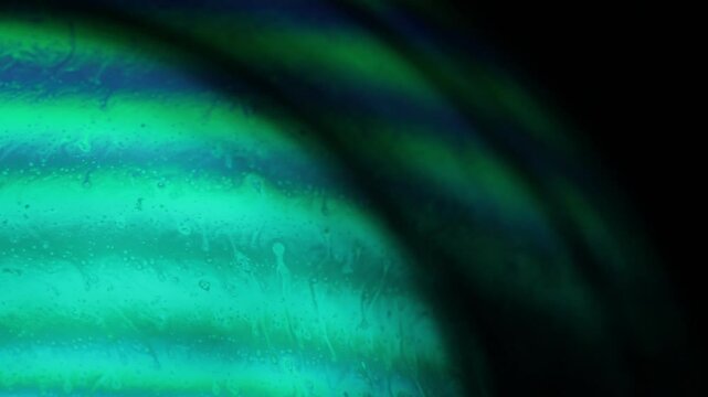 Bright white rainbow reflection of liquid surface in macro, white colors, surrealistic background, fantastic smooth movement