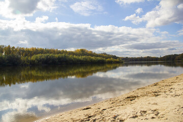 landscape sandy beach on the bank of the river Desna in Chernigov, dense forest behind the river