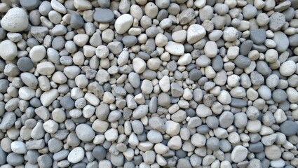 Elegant pebble mosaic wall with smooth gray and white stones in decorative pattern