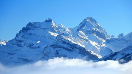Obraz premium Snow-covered mountains, clear blue sky and crisp air