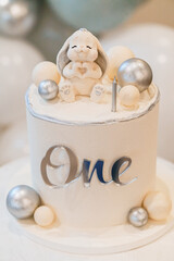 Adorable Bunny-Themed First Birthday Cake with Decorative Elements
