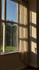 Fototapeta premium Sunlight streaming through a window into a room.