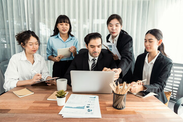 Diverse of business people from various ethnic group working in modern office environment. Productive and multi ethnic office workers engage in discussion for strategic business marketing. Meticulous
