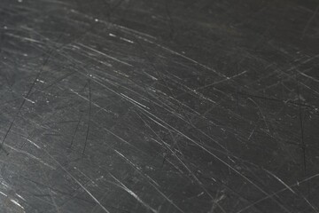 Texture of scratched metallic surface as background, closeup