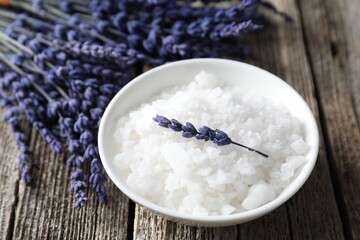 Natural sea salt and lavender on wooden table, closeup