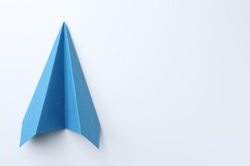 One handmade light blue paper plane on white background, top view. Space for text