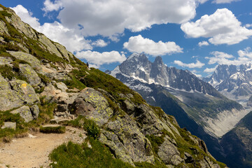 The Petit Dru mountain summit displays rugged peaks and rocky formations against clear sky. Rocky...