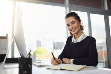 Business woman, portrait and writing intern at desk with notes, schedule and diary planning. Notebook, pen and young professional with planner for online journalism and digital content creation ideas