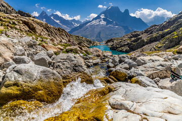 The Petit Dru mountain summit displays rugged peaks and rocky formations against clear sky. Rocky...