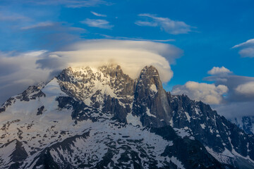 The Petit Dru mountain summit displays rugged peaks and rocky formations against clear sky. Rocky...