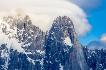 The Petit Dru mountain summit displays rugged peaks and rocky formations against clear sky. Rocky...