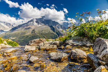 The Petit Dru mountain summit displays rugged peaks and rocky formations against clear sky. Rocky...