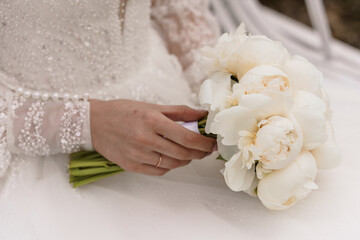 Bride Holding a Beautiful Bouquet of White Peonies in Elegant Wedding Attire