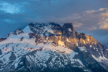 The Petit Dru mountain summit displays rugged peaks and rocky formations against clear sky. Rocky...