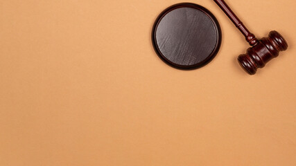 Gavel down on stand on brown background. Justice of law system conceptual.