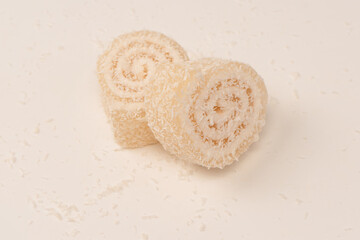 Coconut candy roll isolated on a white background.