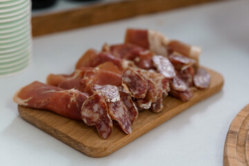 Assorted Cured Meats on a Wooden Board