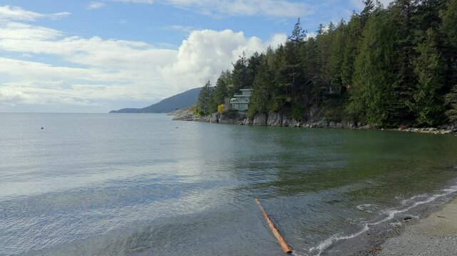 Establishing shot. Luxury house with nice Fall ocean view and rocky landscape in Vancouver, Canada, North America. Day time on October 2023. ProRes 422 HQ.