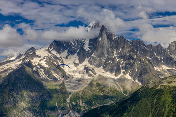 The Petit Dru mountain summit displays rugged peaks and rocky formations against clear sky. Rocky...