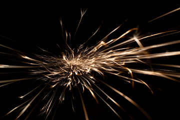 sparks from the grinder glowing in the dark