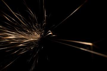 sparks from the grinder glowing in the dark
