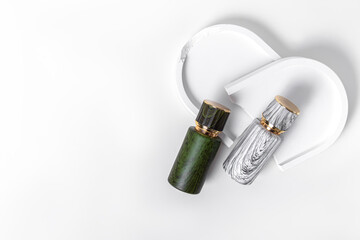 Two perfume bottle with wood texture pattern on white background. Free space for text