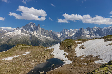 The Petit Dru mountain summit displays rugged peaks and rocky formations against clear sky. Rocky...