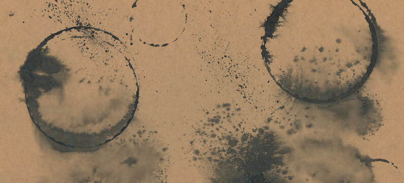 Black grunge Ink brushstroke painting smear circle drop blot. Abstract contrast grunge stain on beige craft paper background.