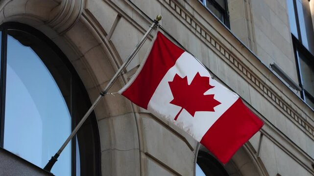 Canadian flag on building downtown district of Ottawa in Canada, close up