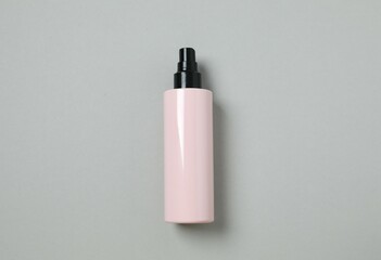 Cosmetic bottle on gray background