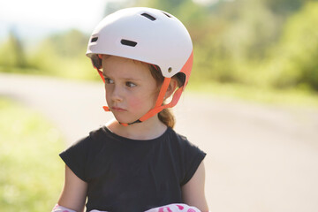 Little cute girl in helmet close up. Child safety concept