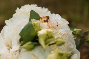 Romantic Wedding Rings Resting on Elegant White Flowers